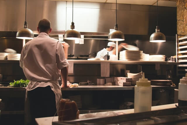 Accueil chef standing in restaurant kitchen